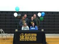 Kayla and Hannah with their parents after signing their national letters of intent.
